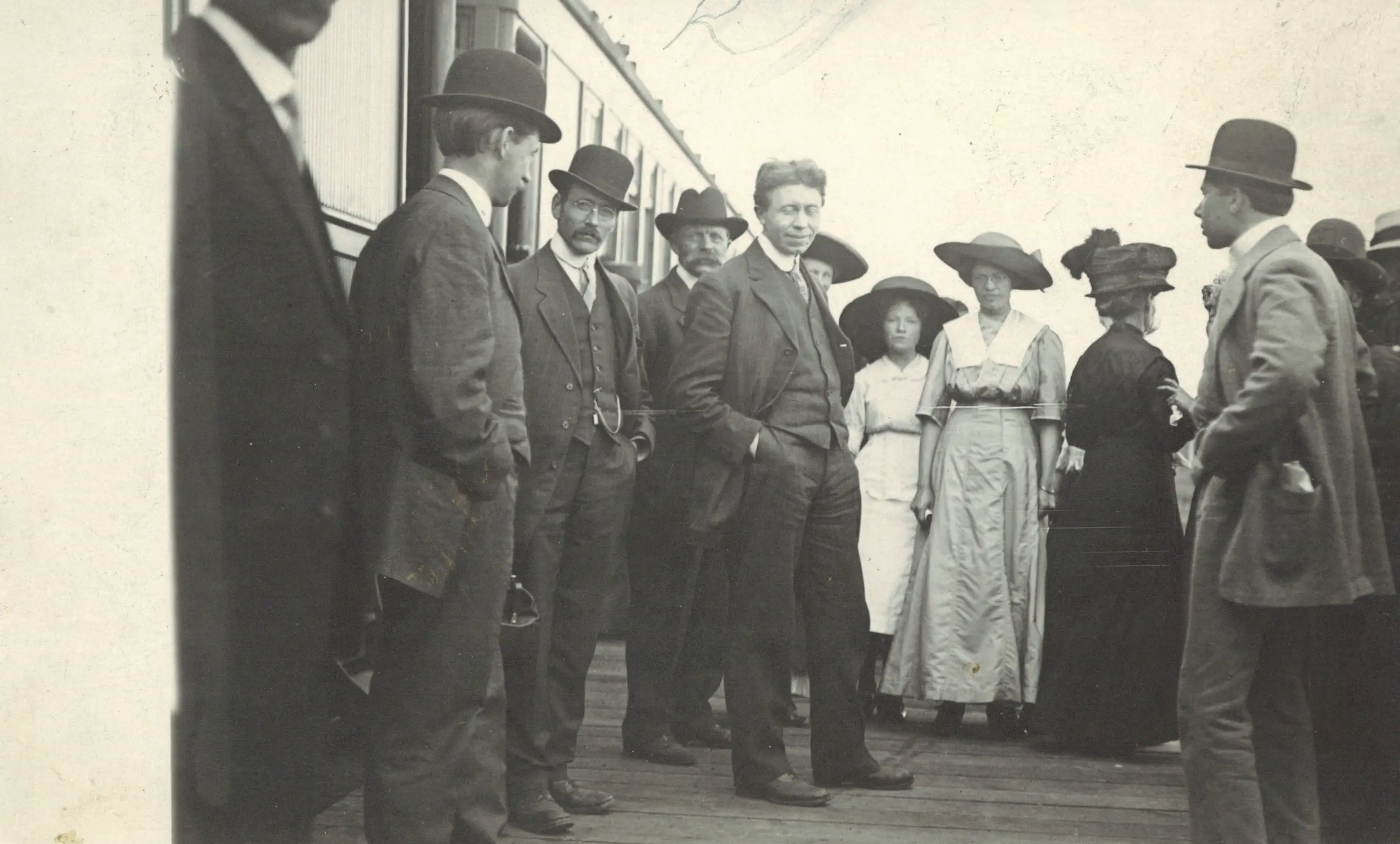 Crowd gathered on the station platform beside a train